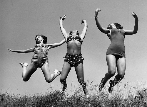 6. Three Windmill Theatre dancers enjoying the sun on the beach at Angmering during a break in rehearsals, 1952.